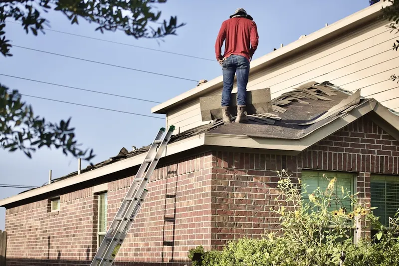 Professional roofer working on a residential roof in Deschutes River Woods